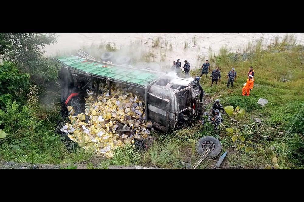 Truck loaded with cooking oil falls 200m below road in Dhading