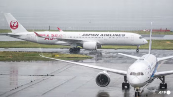 Japan cancels 120 flights as twin storms approach