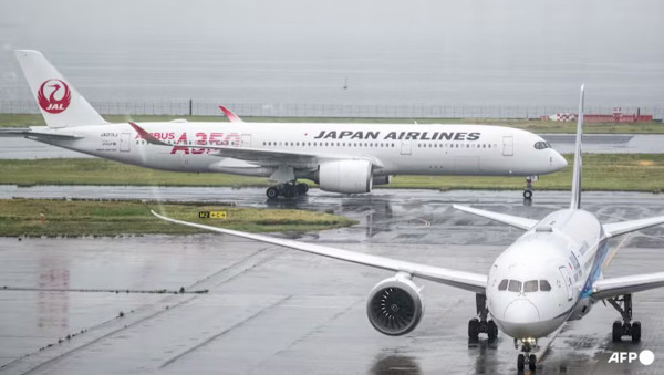 Japan cancels 120 flights as twin storms approach